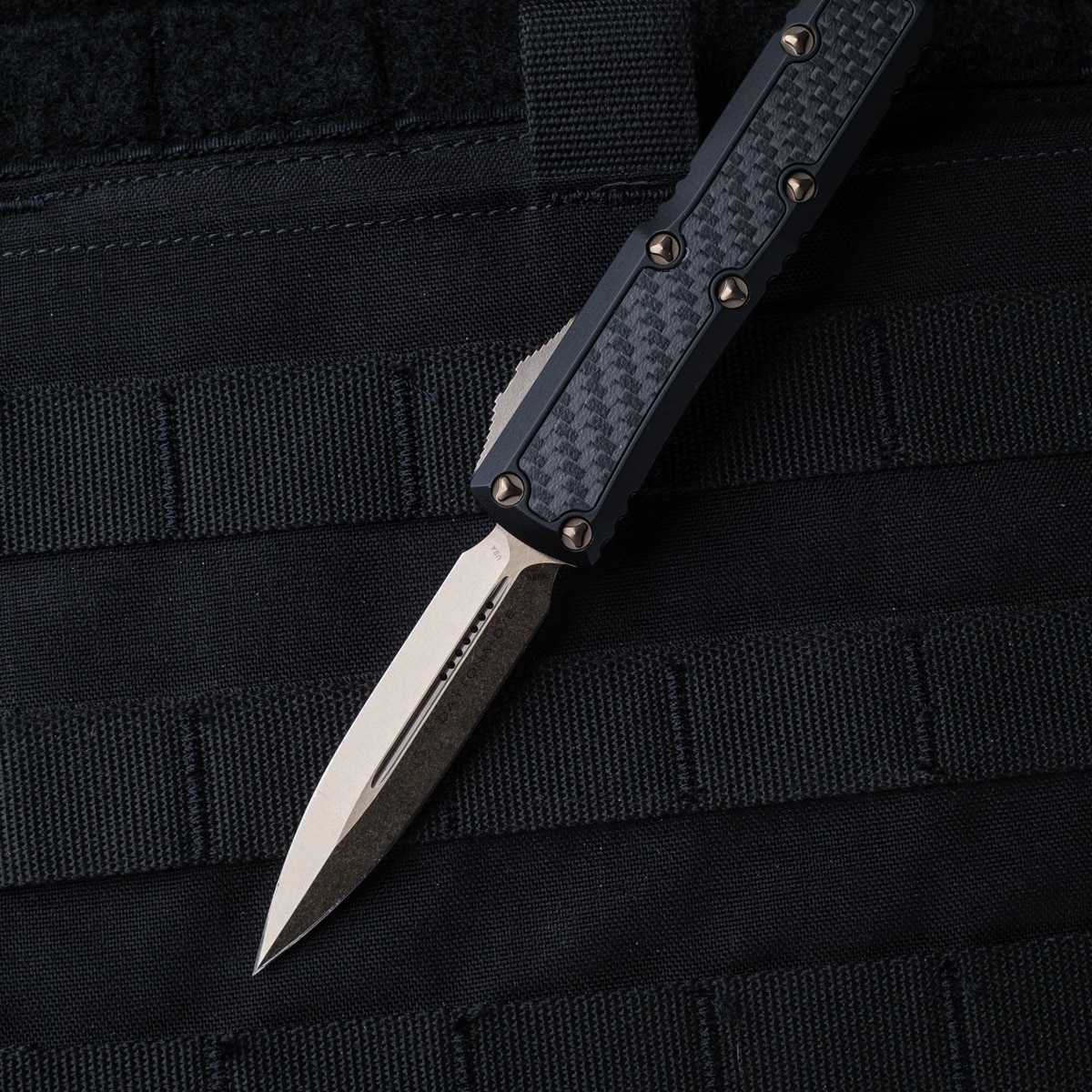 https://cityarsenal.com/product/microtech-daytona-signature-series-o-t-f-auto-knife-d-e-bronzed-standard-blade-black-handles-with-carbon-fiber-inlays-126-13cfis/